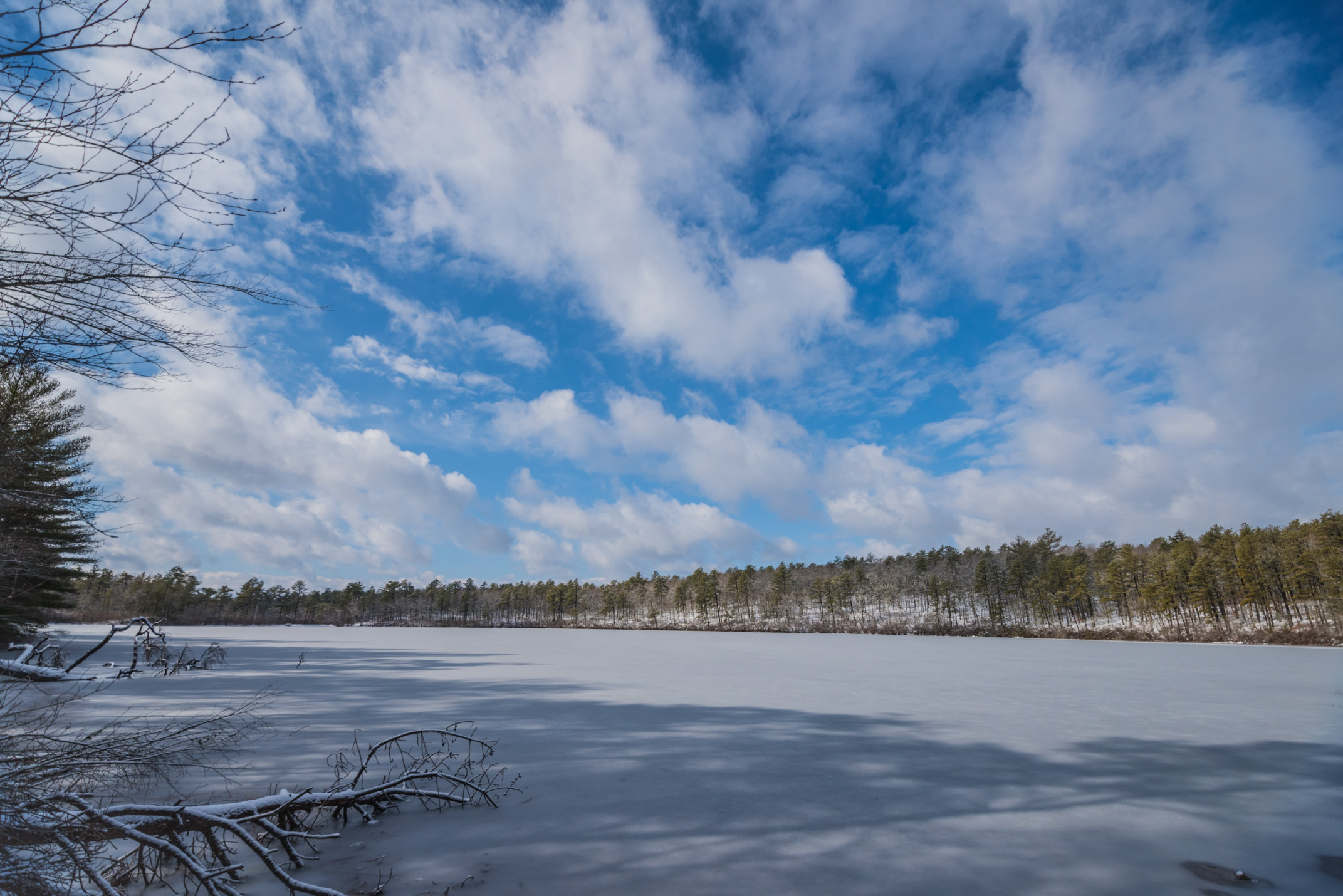 A big, blue sky floats over a frozen pond in Plymouth, Massachusetts.